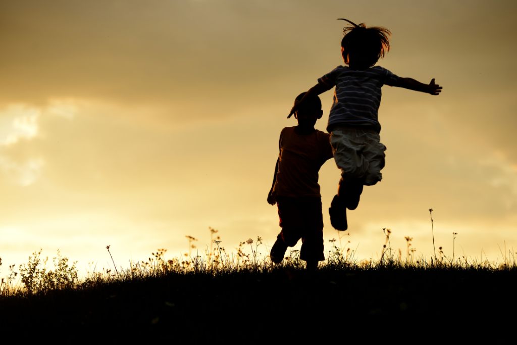 Kids jumping during sunset