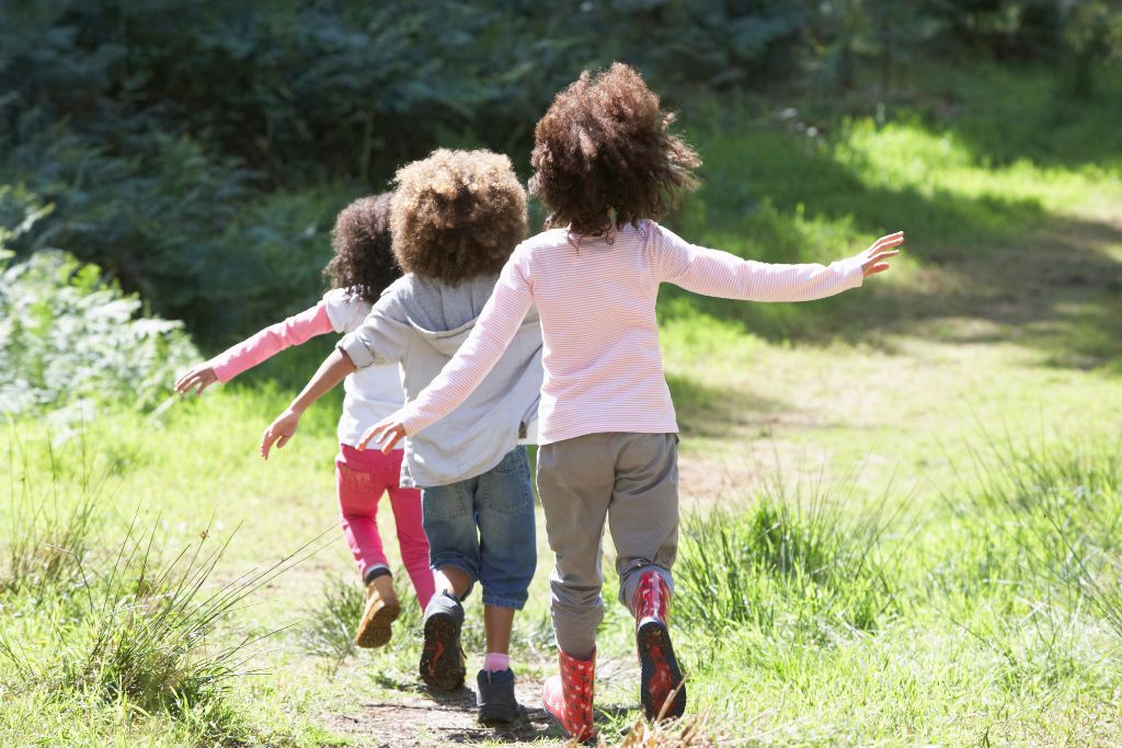 Children running on a field. A photo of a blogpost Positive parenting: How children learn from what we model